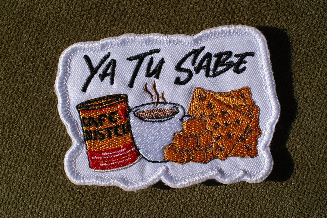 Ya Tu Sabe coffee and snacks embroidered patch

Latino culture coffee crackers and cheese patch

Ya Tu Sabe patch embroidery detail

Spanish phrase patch displayed on a denim jacket
