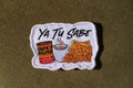 Ya Tu Sabe coffee and snacks embroidered patch

Latino culture coffee crackers and cheese patch

Ya Tu Sabe patch embroidery detail

Spanish phrase patch displayed on a denim jacket
