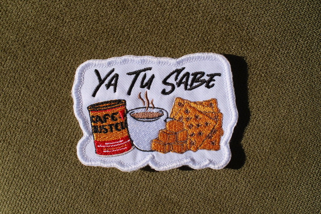 Ya Tu Sabe coffee and snacks embroidered patch

Latino culture coffee crackers and cheese patch

Ya Tu Sabe patch embroidery detail

Spanish phrase patch displayed on a denim jacket